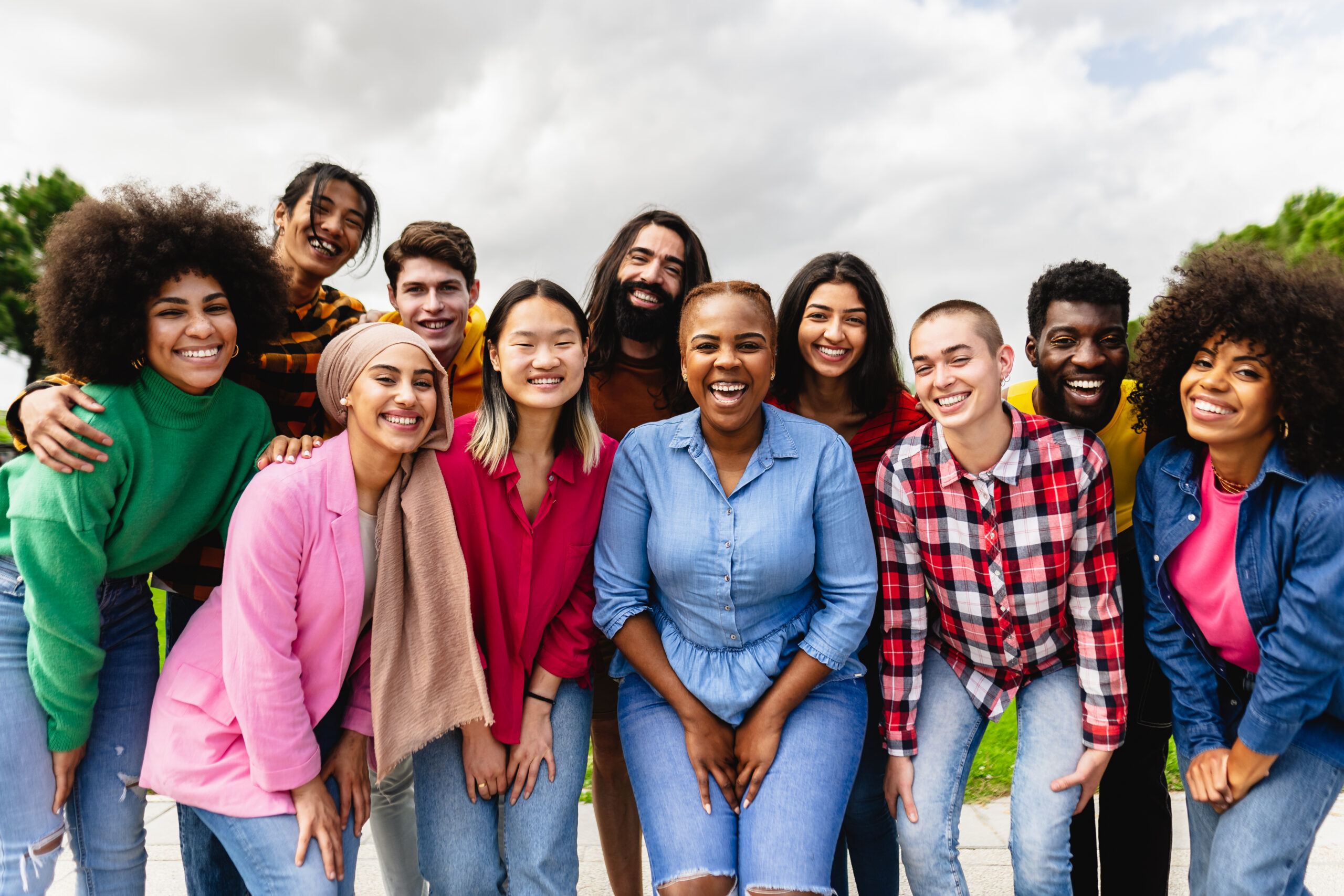 Young multiracial friends having fun together hanging out in the city - Friendship and diversity concept