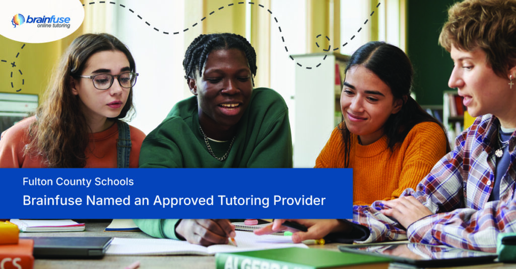 Four students sit together at a classroom table, looking at a tablet and schoolwork. A blue text panel reads, “Fulton County Schools: Brainfuse Selected for Tutoring Provider Pool.”